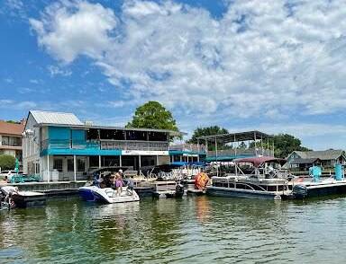 Albright Land & Development at Cedar Creek Lake | Boat docked outside of Tiki Hut, a restaurant and bar on Cedar Creek Lake.